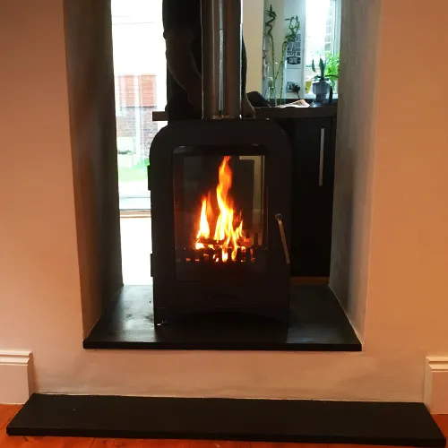Wood burning stove installed in a living room by Chimney Geeks